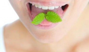 Breath Treatment A young lady using mint as a breath treatment.