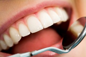 Dental Patient Education Dental Patient Education - A picture of a beautiful smile with a dental mirror.