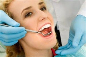 Regular Check Ups A young lady is having her regular checkup, dental exam. Beautiful smile.