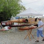 Lady setting up boat show on the waterfront.