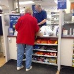 Waiting in line to have my prescription filled at the local pharmacy.